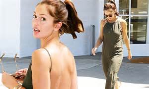 minka kelly shows some skin in a backless olive green