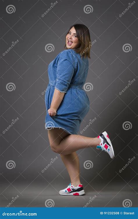plus size fashion model in casual clothes fat woman on gray background