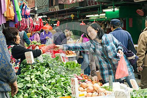 Woman Buying Vegetables In The Street Market Hong Kong