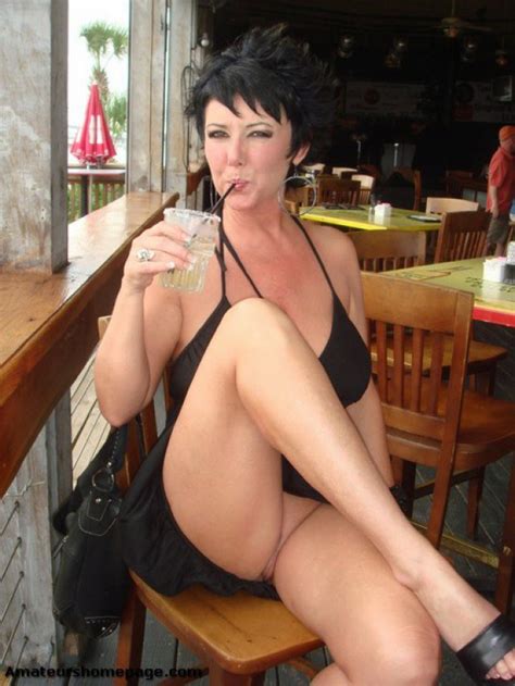 wife shows upskirt while sipping a drink