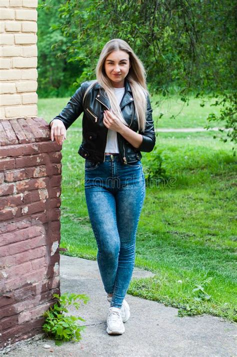 Very Beautiful Blonde In Jeans And Black Jacket In Spring Or Summer