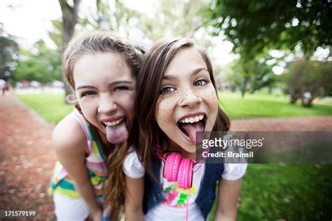 sticking out tongue girls photos and premium high res pictures getty