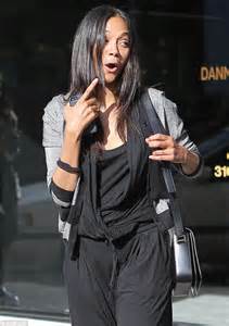 zoe saldana laughs as husband marco perego tries to hand her the car