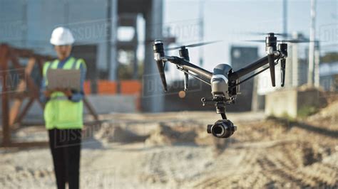 specialist controlling drone  construction site architectural