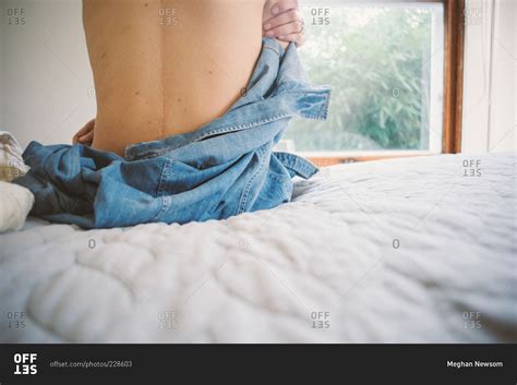 woman    shirt  siting   edge   bed stock photo offset