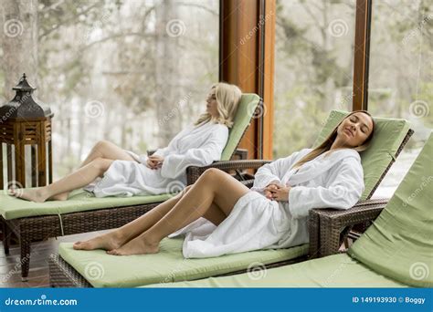 young women relaxing   deckchair   swimming pool  spa stock