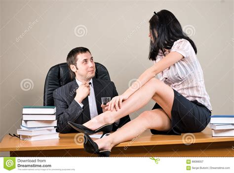 businesswoman is seducing her boss at office stock image