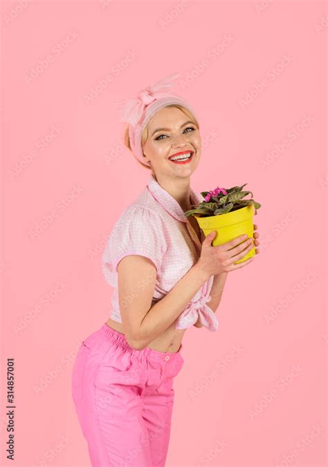 Smiling Pinup Girl Holding Flowers In Pot Girl Cultivating Flowers