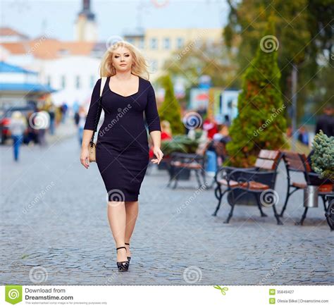 Confident Overweight Woman Walking The City Street Stock