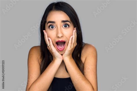 woman shocked scared terrified surprised holds face omg isolated on