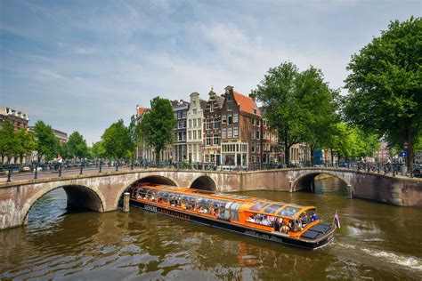 orange canal boats  amsterdam canals  amsterdam