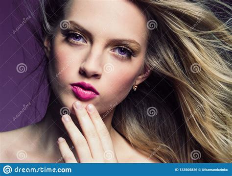 Beautiful Blonde Girl With Long Curly Hair Over Purple Background Stock