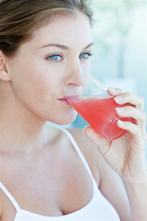 woman drinking cranberry juice photograph by ian hooton science photo