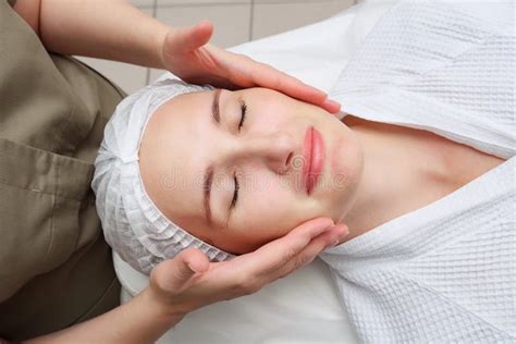 Masseuse Does Face Massage To Woman In Medical Clinic Stock Image