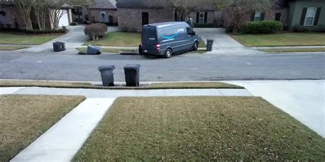 caught on camera amazon delivery van rolls down driveway hits light pole