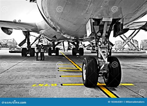 landing gear   airplane parked   gate boeing  editorial photo image  monotone