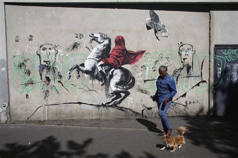 street artist banksy splashes paris  works  migrants ap news