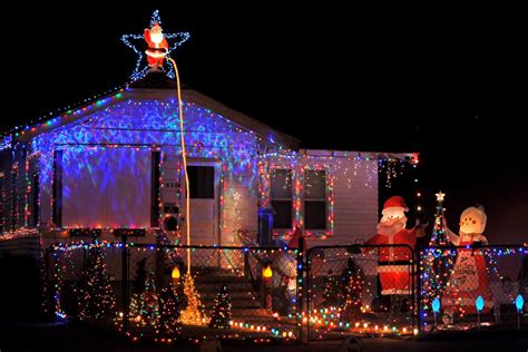 peeing santa light display offers christmas greetings on