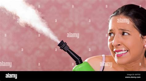 Brunette Woman Holding Steam Cleaner Machine And Vapor Coming Out