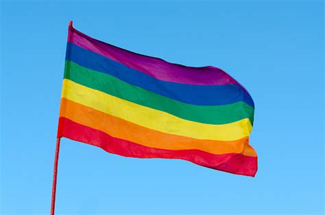 rainbow gay pride flag on blue sky background usa stock