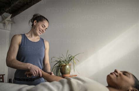 A Female Massage Therapist Works On An African American Female Client