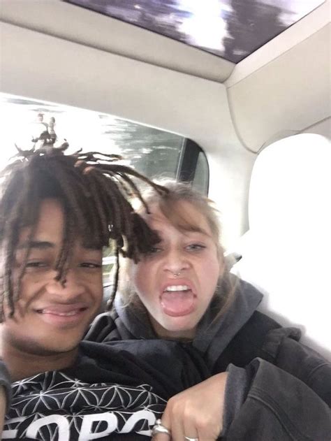 Two People Sitting In The Back Seat Of A Car One With Dreadlocks