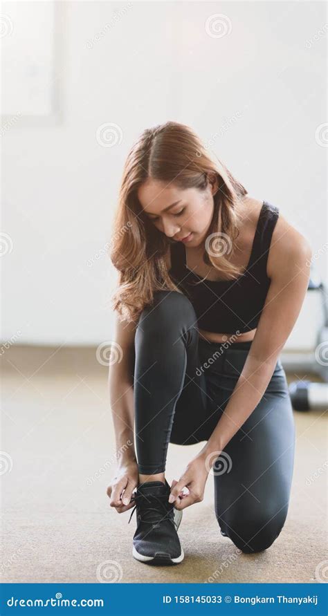 Young Slim Fitness Girl Doing Shoelaces In The Sport Gym Stock Image