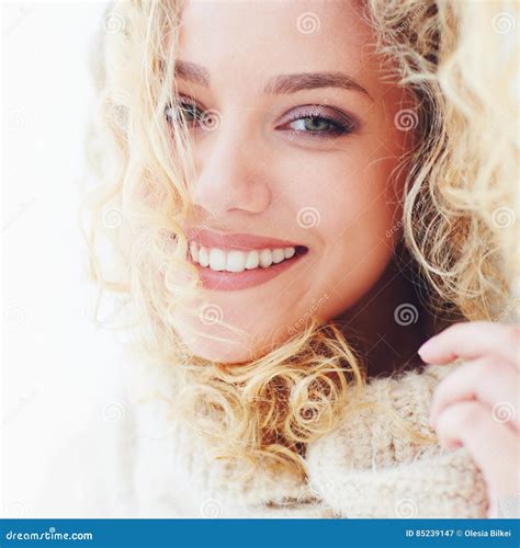 portrait of beautiful happy woman with curly hair and adorable smile