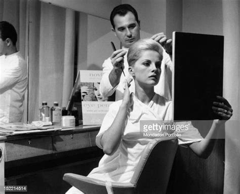 italian actress virna lisi watching herself in the mirror while the