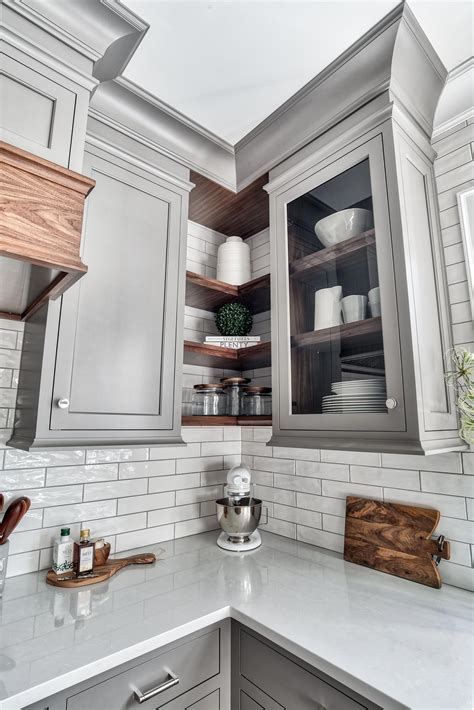 custom gray cabinetry  natural walnut floating shelves glass cabinet  walnut interior