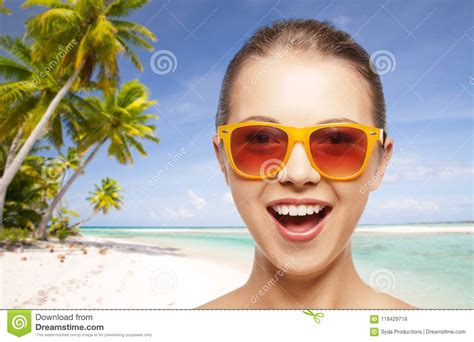 happy woman or teenage girl in sunglasses on beach stock