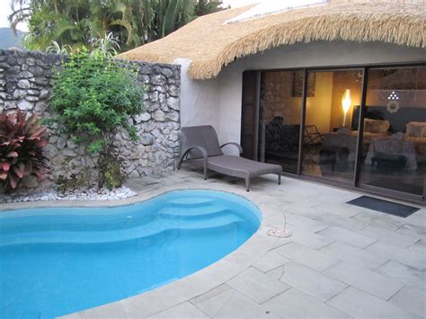 small pool  front   stone wall   thatched roof