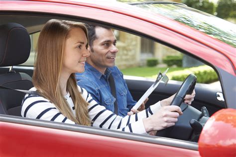 woman having driving lesson with instructor driving instructors