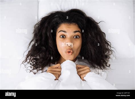 African American Young Woman Lay In Bed Posing Making Funny Faces