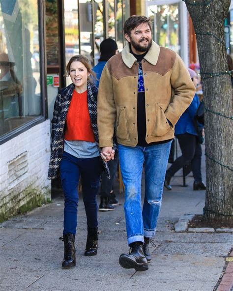 anna kendrick holds hands with a fellow actor while
