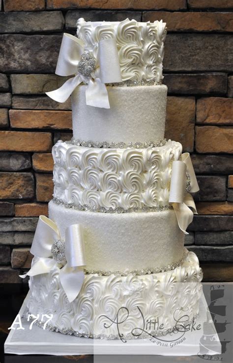 a77 buttercream wedding cake with fancy swirls and bows