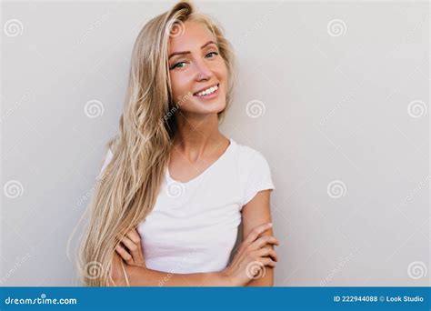 dreamy tanned woman smiling  indoor photoshoot debonair female