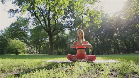 pretty girl doing yoga and pilates in the park in the sunny morning