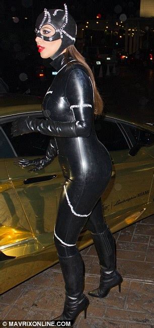 kim kardashian dresses as catwoman as she arrives at