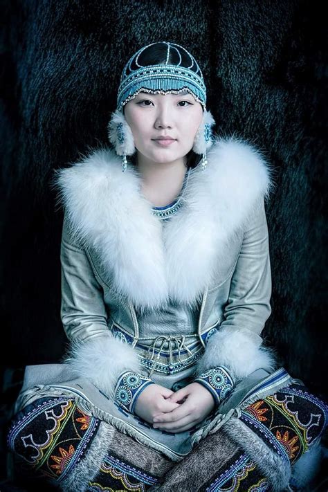 Evenki Woman From Northern Siberia In Traditional Garb With Reindeer