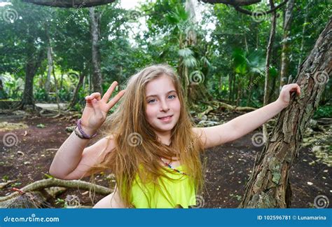 caucasian girl playing victory sign  jungle stock image image
