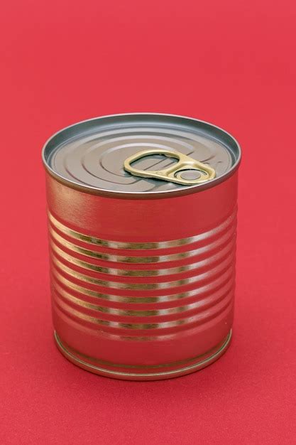 Premium Photo Unopened Tin Can With Blank Edge On Red Background