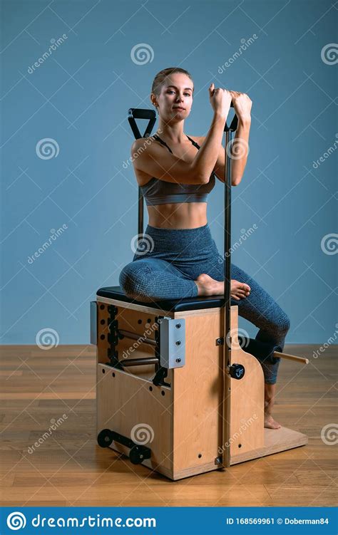 pilates woman in a reformer doing stretching exercises in