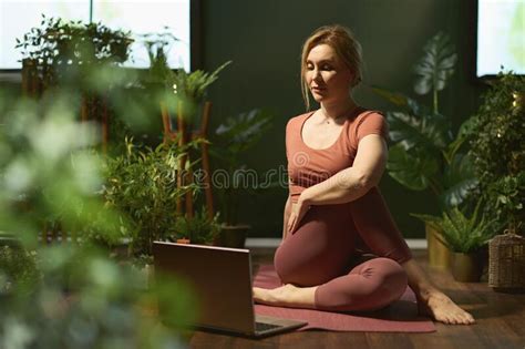 Modern 30 Years Old Woman Stretching In Modern Green House Stock Image