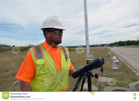 surveyor working   field  safety vest  hard hat stock photo image  prism