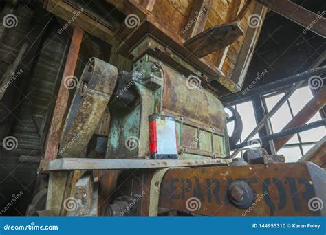 antique belt driven grist mill equipment  oil  stock photo image  feed olden