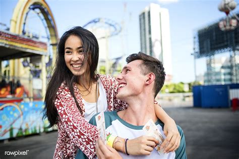 Download Premium Photo Of Young Couple Having Fun Together At An Amusement