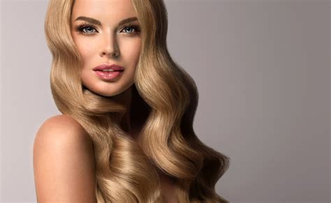 blonde girl with long and volume shiny wavy hair