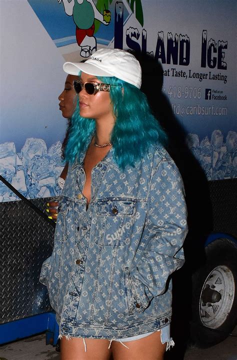 rihanna wearing a turquoise wig at a carnival event 18