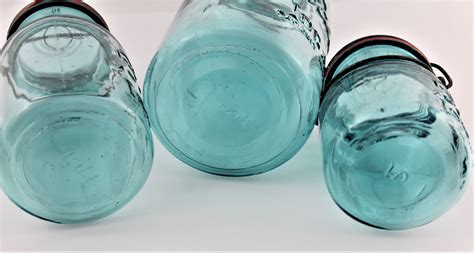 vintage set of 1920s blue ball mason canning jars with glass lids